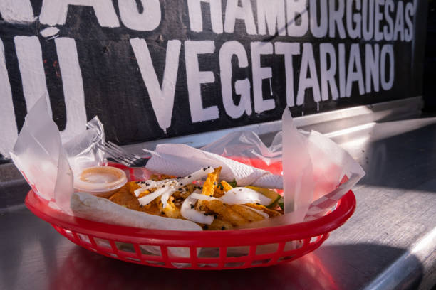 istock Fries and onions on a plastic basket with words behind it 1292069490