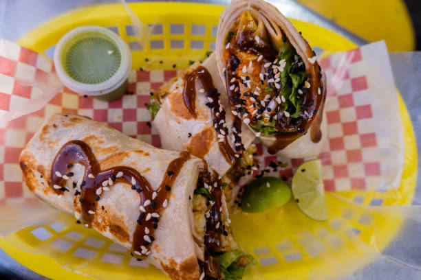 istock Burritos covered with sauce and seeds on a plastic basket 1292069546