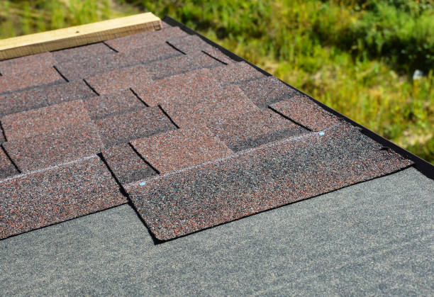 istock Lying down asphalt shingles on house rooftop. Roofing construction concept 1292069759