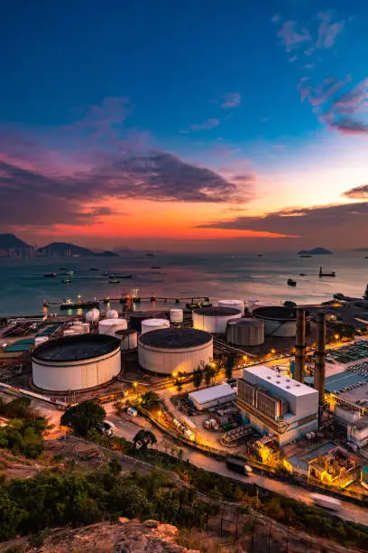 Photo of The tank is in the light of the industrial area. With the sky of the sunset.