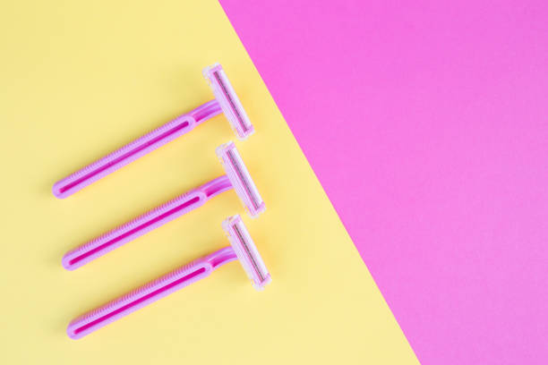 istock Three women's razors pink on an isolated pink and yellow background 1292070355