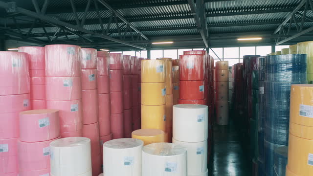 Paper-producing factory unit with multiple rolls of coloured paper