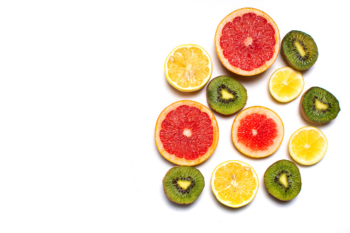 Citrus fruits lemon kiwi and grapefruit on white background isolated with copy space