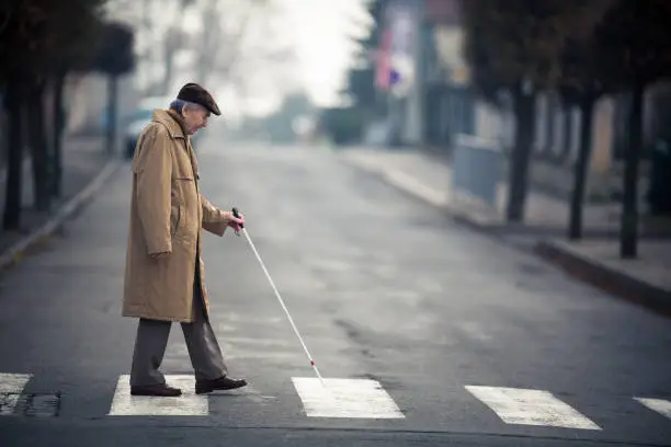 Blind man crossing a street