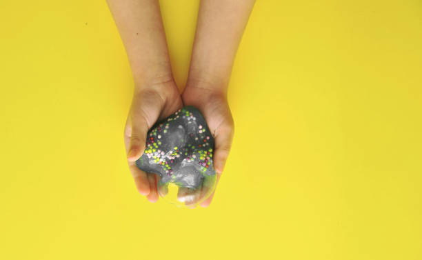 istock Child hands with slime on colorful background. 1292076771