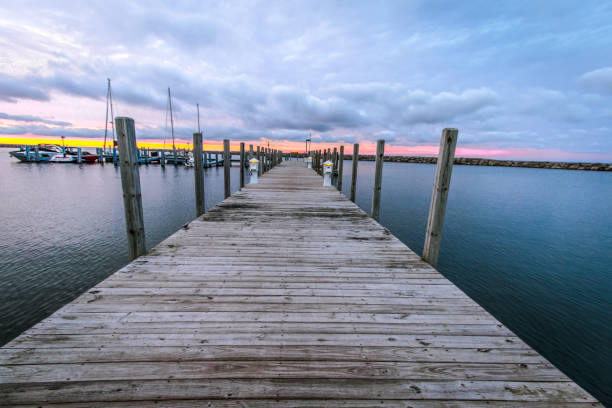 A view from the dock of a lake (Lake Charlevoix, Michigan, USA), framed by the bow of a blue boat