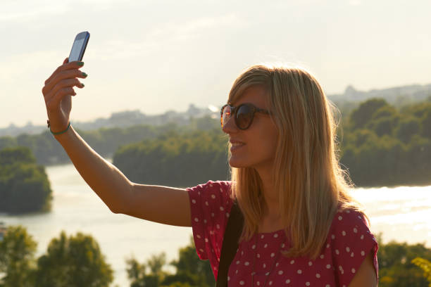 istock Young woman using modern smartphone in urban surroundings. 1292081207
