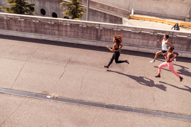 istock High angle photo of three women running 1292082926