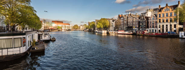 istock Amsterdam Netherlands dancing houses over river Amstel landmark 1292083085