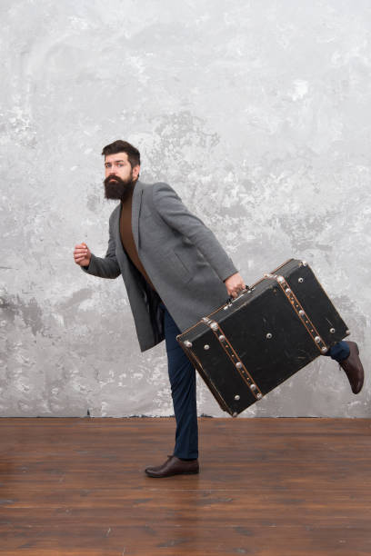 istock Travel and baggage concept. Hipster traveler with baggage. Ready for relocation with baggage. Start journey. On way to new life. Luggage insurance. Man well groomed bearded hipster with big suitcase 1292087059