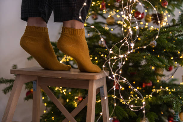 istock Decorating Christmas Tree at Home Feet Close Up 1292088230