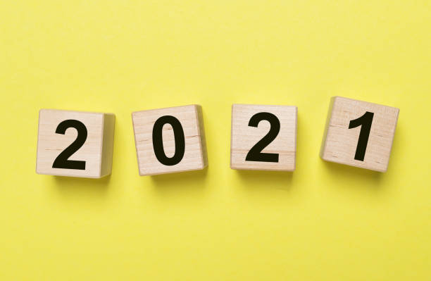 istock 2021 new year inscription. Yellow background 1292088949