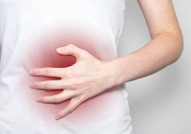 istock Liver pain point. Hand holding body part 1292089007