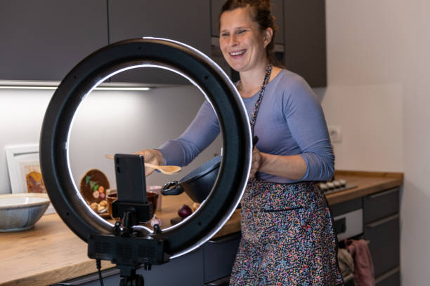 istock Cooking and live streaming video on smartphone with LED ring light 1292089140