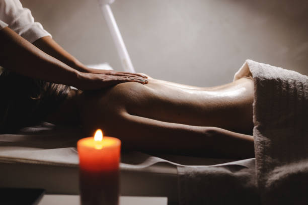 istock Young woman relaxing during back massage at the spa 1292090593