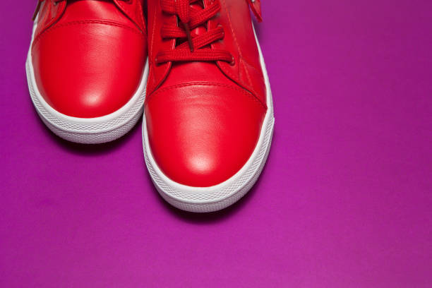 istock Sport red leather sneakers on red background 1292092688