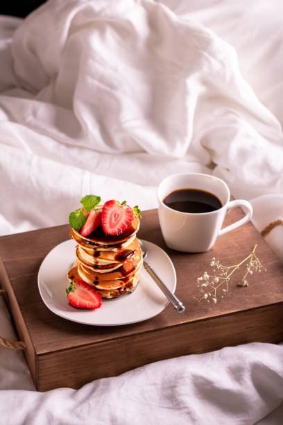 istock Breakfast in bed with coffee and pancakes 1292095046