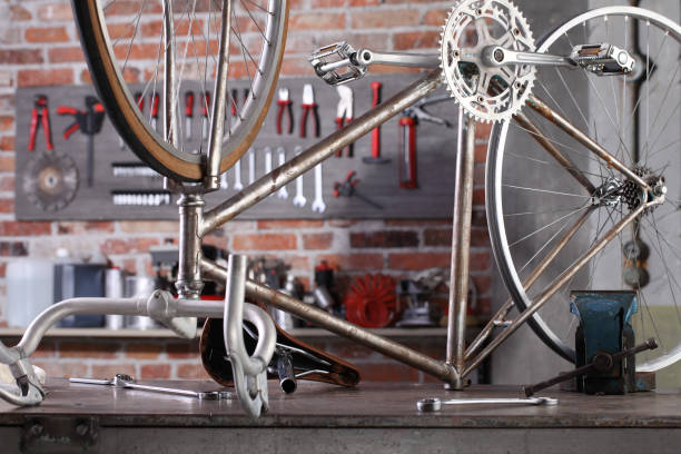 istock vintage bicycle in garage workshop on the workbench with tools, diy concept 1292096371