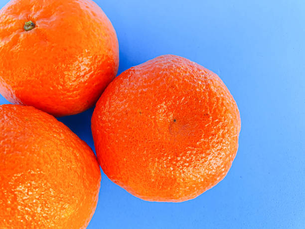 istock Fresh Mandarin on blue background. Vitamins. Tropical fruits 1292097348