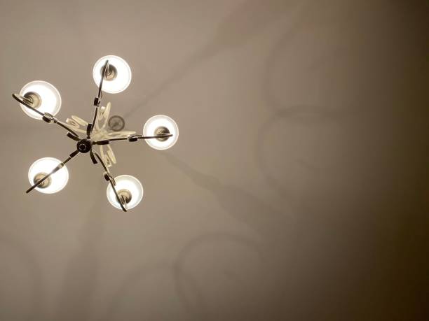 istock Chandelier-a branched often ornate lighting fixture suspended from a ceiling. 1292097595