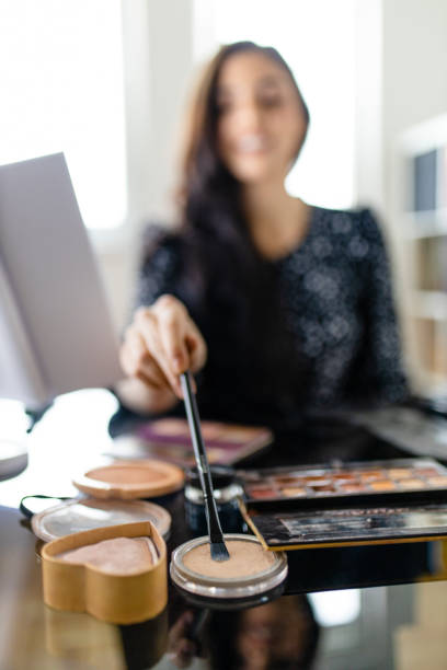 istock Portrait of young female make up artist preparing tools for filming tutorial 1292098524