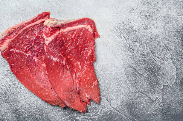 istock Raw fresh veal meat chop steak.  White background. Top view. Copy space 1292100118