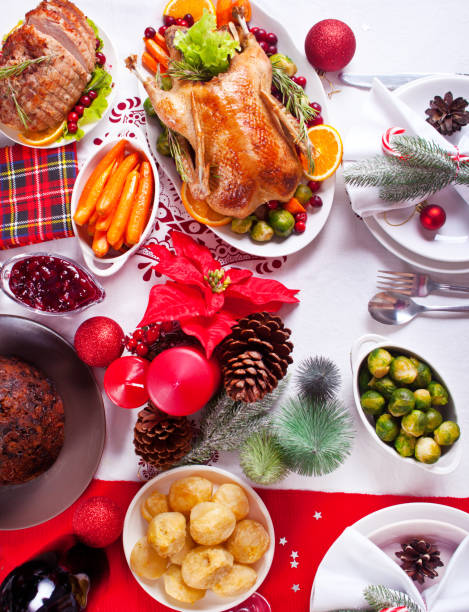 istock Table served for thanksgiving or Christmas dinner. Stuffed roasted turkey in the foreground. Traditional celebrating holiday. 1292100986