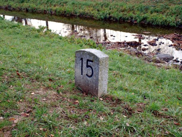 istock Stone slab with the number in the green grass 1292101222