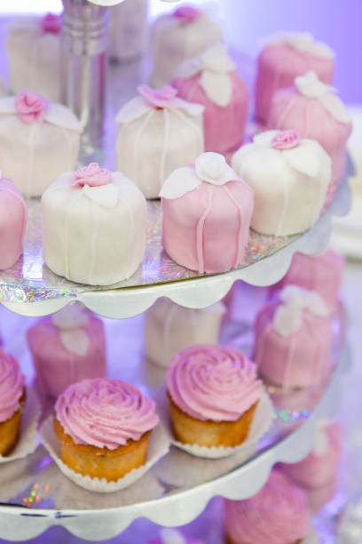 istock Cupcakes and other cakes with icing on glowing paper on plate 1292101345