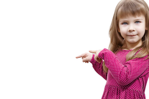 istock little girl points to a white background 1292102286