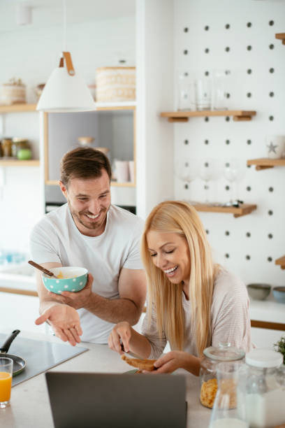 istock Young couple making breakfast at home. stock photo 1292102371