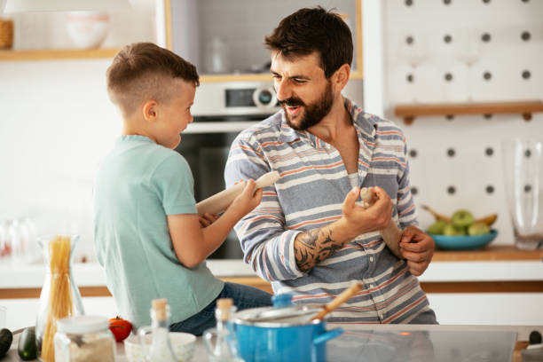 istock Father and son prepare breakfast in the kitchen stock photo 1292102733