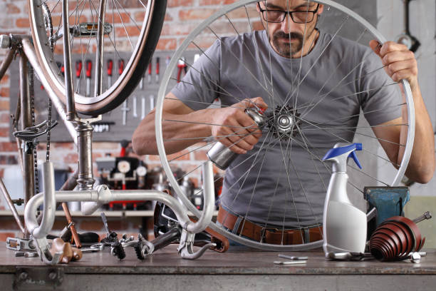 istock man repair the vintage bicycle in garage workshop on the workbench with tools, diy concept 1292103173