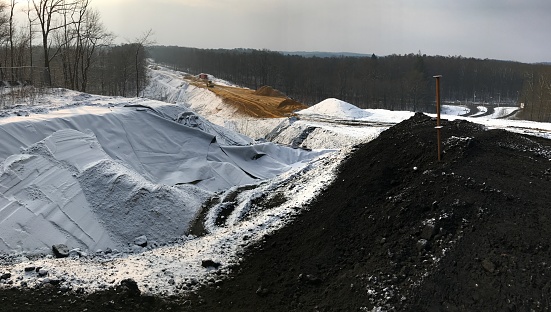 Panoramic view of a Construction site in winter for a new highway  in the country.
