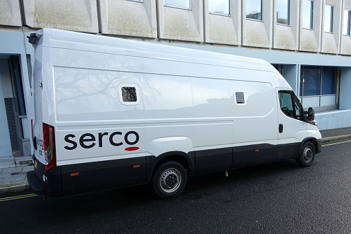 Plymouth England December 2020. Company logo for SERCO on the side of a white van used to transport prisoners. Company provides public services such as Justice, immigration, transport and Healthcare.