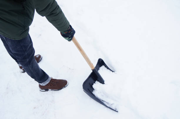 istock a man removes snow with a shovel 1292105311