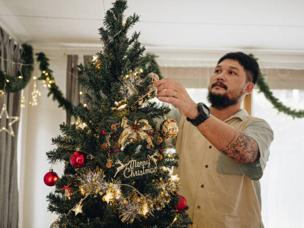 istock Cheerful family decorating Christmas tree. 1292107267