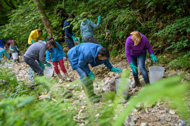 istock Mixed age group of people picking up rubbish 1292107540
