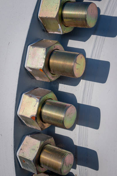 Metal bolts on a galvanized fence post with rust elements and engineering design details.