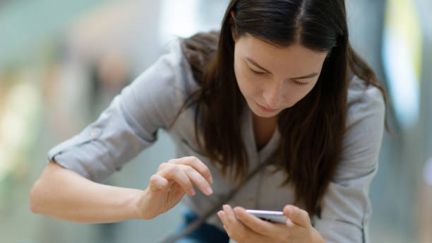 istock A young woman uses a smartphone for work and communication, useful mobile applications in modern phones. 1292111112