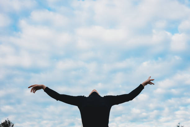 istock Young woman dancing with spread hands in a nature 1292111248