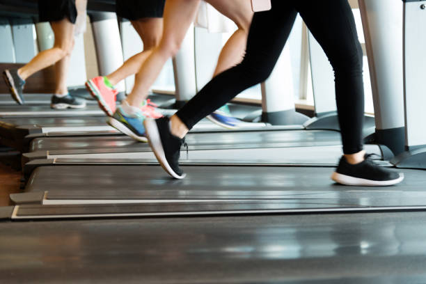 istock Unrecognizable people running on treadmills 1292112271