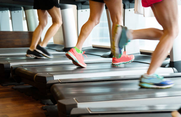 istock Unrecognizable people running on treadmills 1292112360