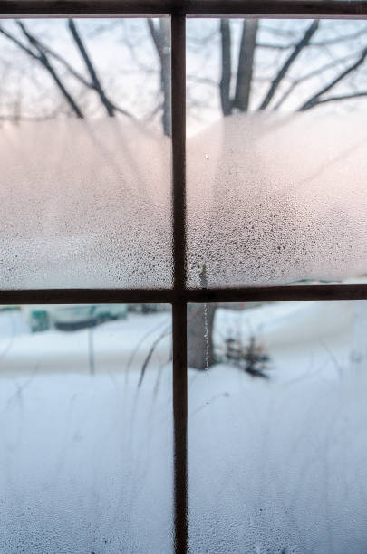 istock Condensation and frost on a window 1292114955