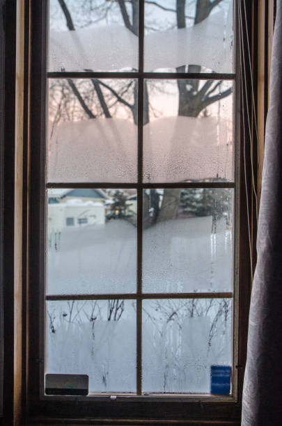istock Condensation and frost on a window 1292115098