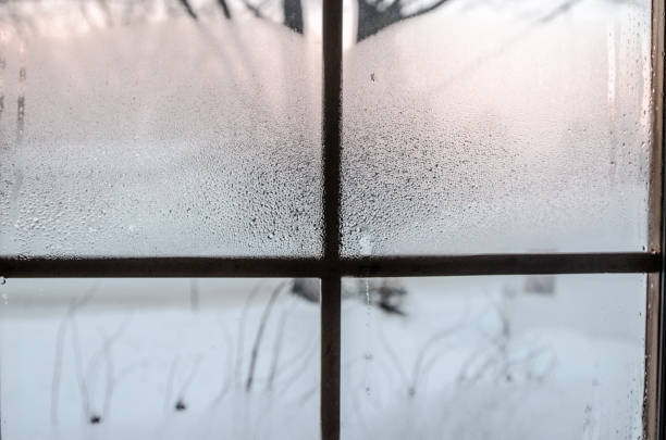 istock Condensation and frost on a window 1292115123