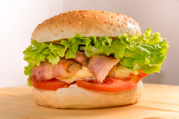istock stuffed hamburger with salad, tomato, bacon and melted cheese 1292115198