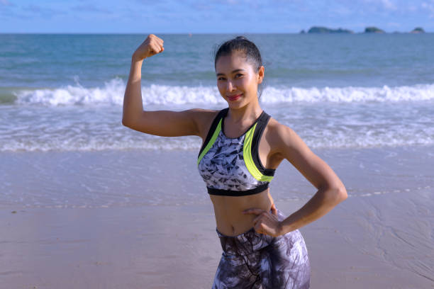 istock woman exercise on the beach. 1292115292