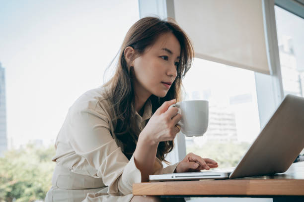 istock Asian woman working in cafe 1292116098
