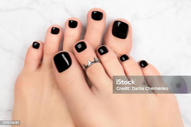Womans Feet On Marble Background Beautiful Classic Black Nail Design Stock Photo - Download Image Now